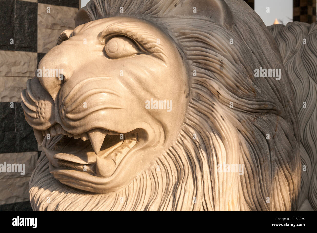 Stone carving of a growling male lion, Danang, Vietnam Stock Photo