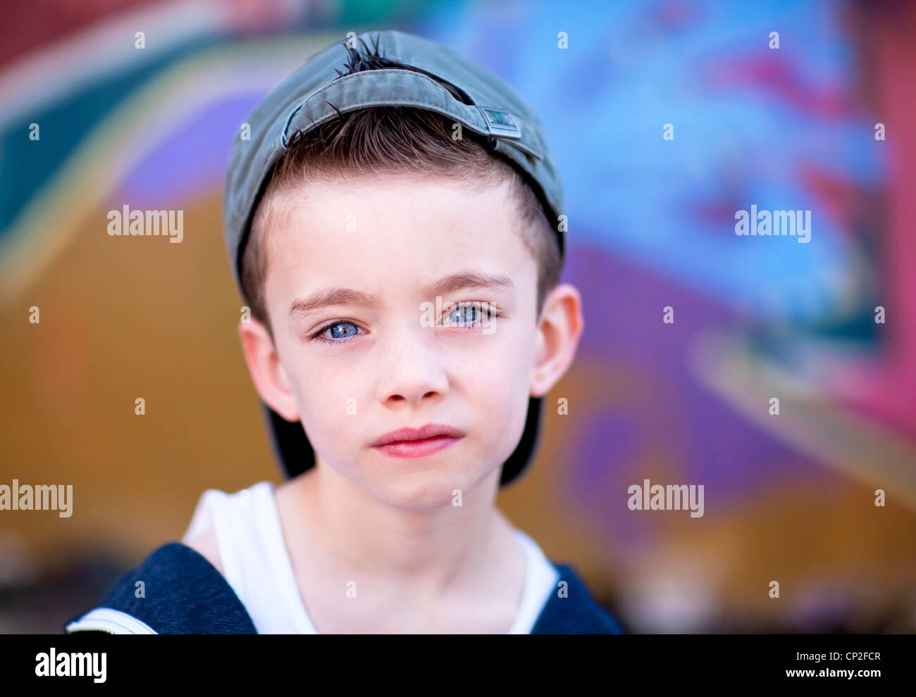 Young boy against graffiti wall Stock Photo