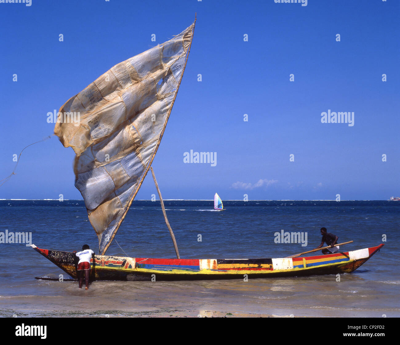 Colourful dug-out fishing boat with sail, North Coast, Mombasa, Mombasa County, Republic of Kenya Stock Photo