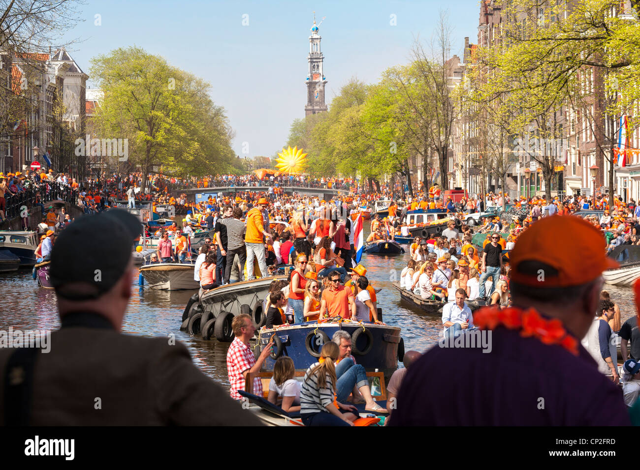 Kingsday Kings Day King's Day in Amsterdam. Canal Parade in the Prinsengracht. Boats people wearing orange, partying. Stock Photo