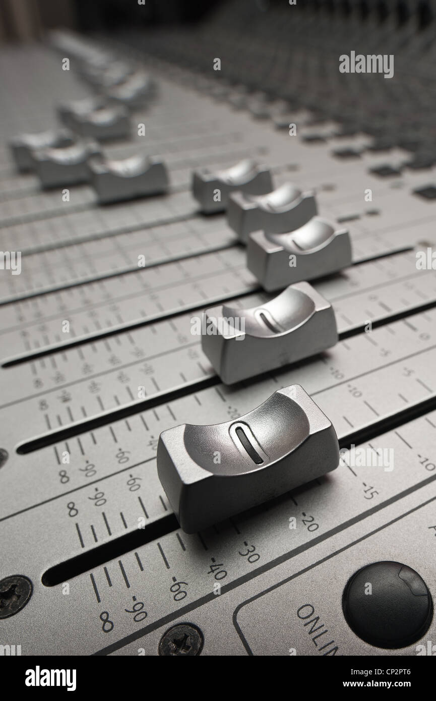 Electronic sound audio mixing desk console in recording studio showing