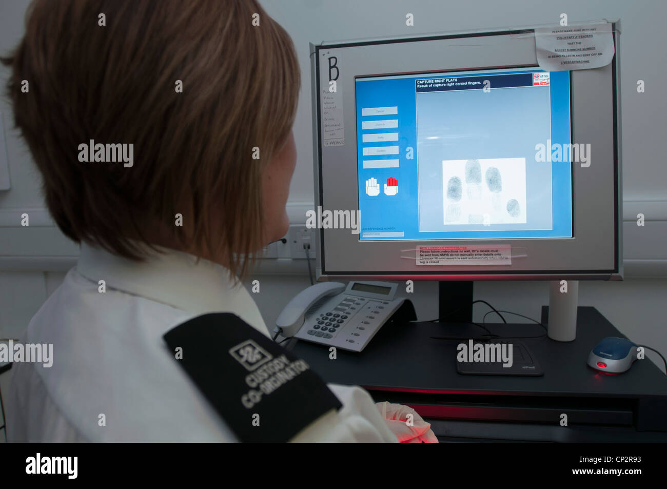 Suspect having digital fingerprints taken in a police station Stock Photo