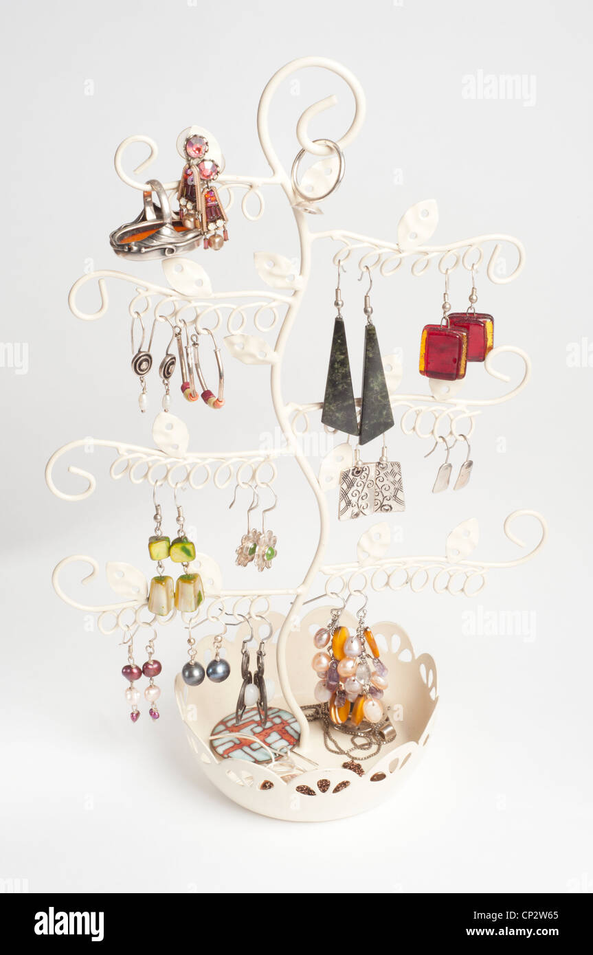 Ear rings stored and displayed on a tree holder. Stock Photo