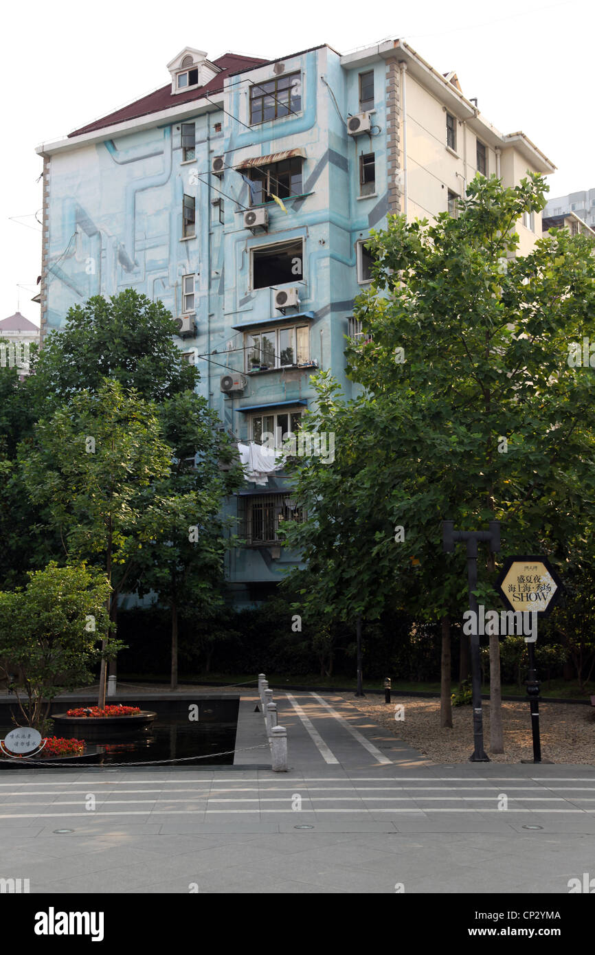 It's a photo of buildings in Shanghai in China. It's a street or a square in a big city. We can see trees and it's polluted. bad Stock Photo
