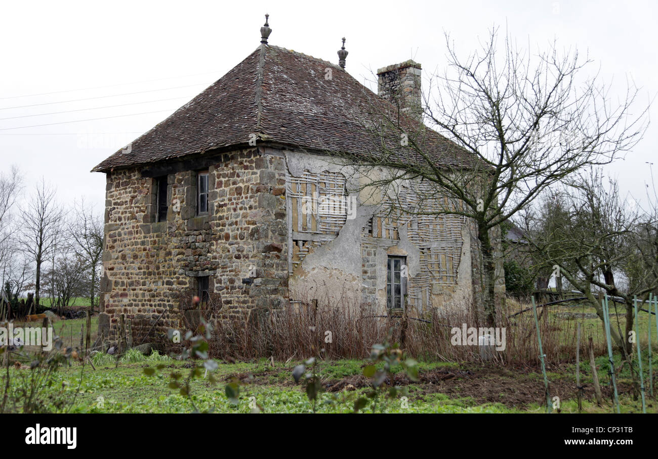 It's a photo of an old house in stone in Normandy in countryside of France. It almost collapses. There is no habitant in it. Stock Photo