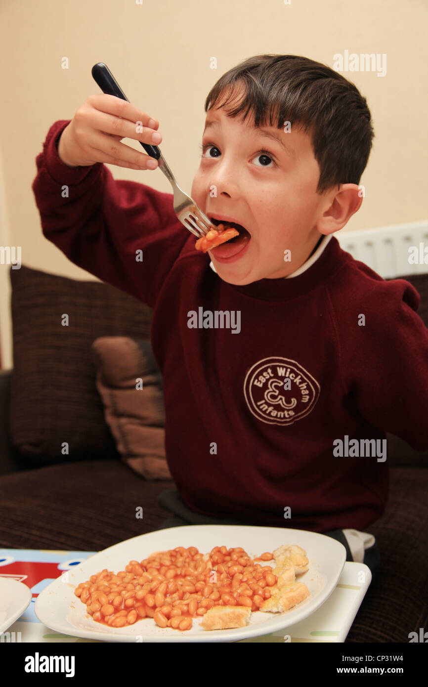 Schoolboy eating lunch of baked beans Stock Photo Alamy