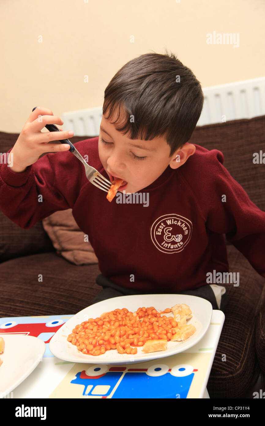 Schoolboy eating lunch of baked beans Stock Photo Alamy