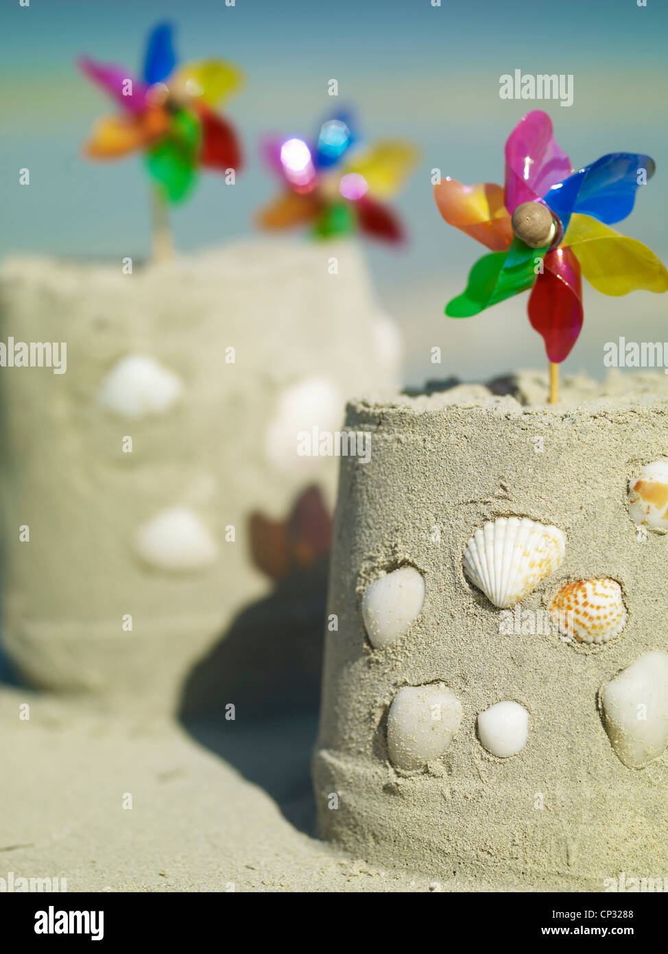 sand castles covered in shells on a beach Stock Photo