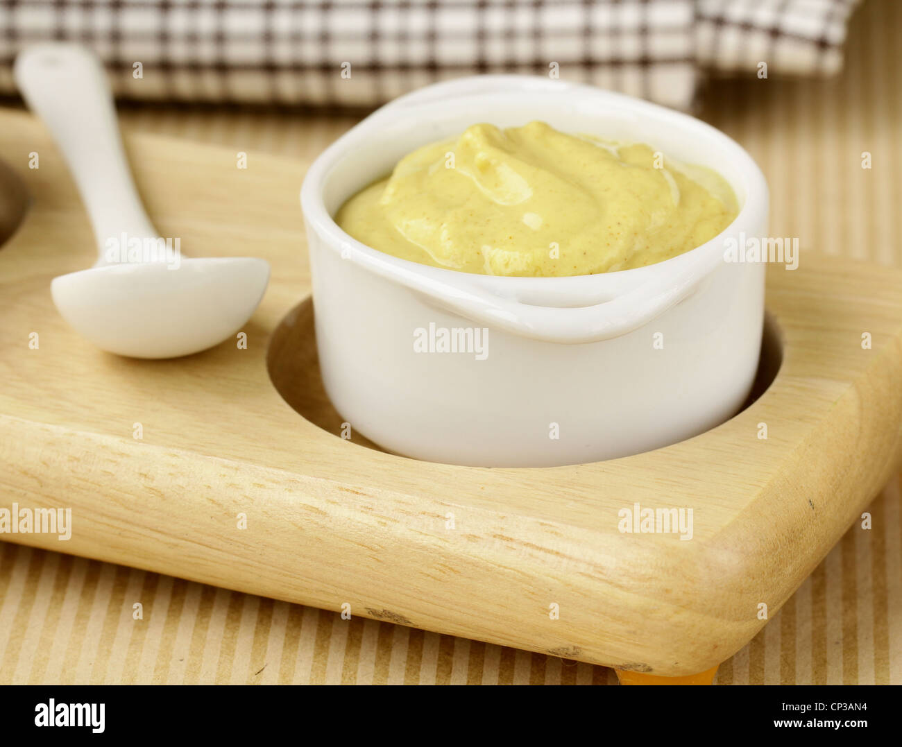 French mustard sauce in white gravy boat Stock Photo