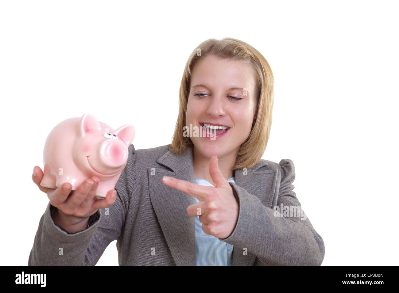 Young woman showing a piggy bank with her finger Stock Photo - Alamy
