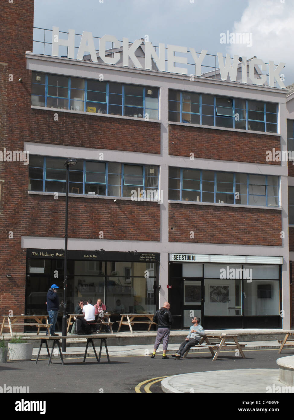 People sitting at a renovated Cafe in Hackney Wick, by London 2012 Olympic Park, UK Stock Photo