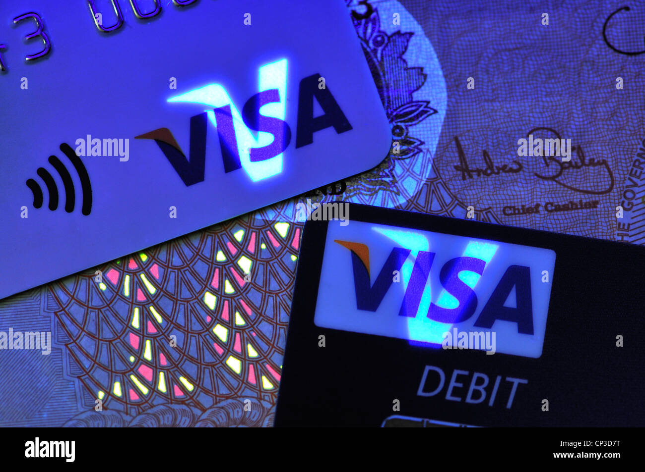 Credit cards and Banknote in ultraviolet light showing security