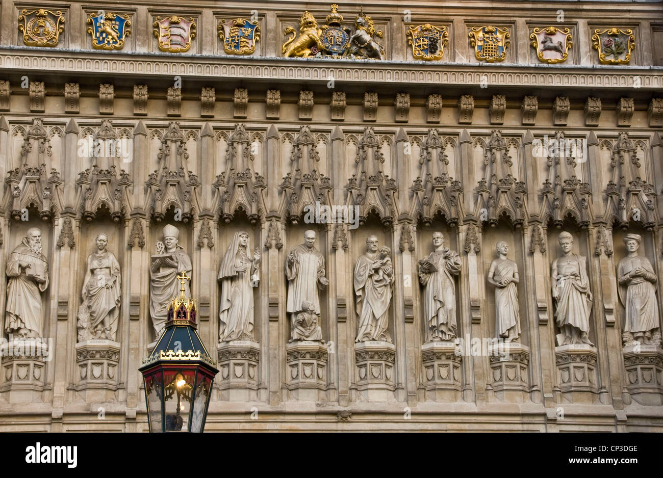 Sculptures carvings of 20th-century Christian martyrs in niches above the west door of Westminster Abbey London England Europe Stock Photo