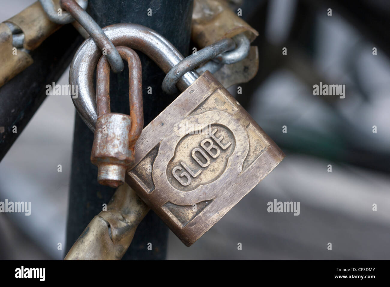 GLOBE brass padlock and chain on a bicycle, Shanghai, China. Stock Photo