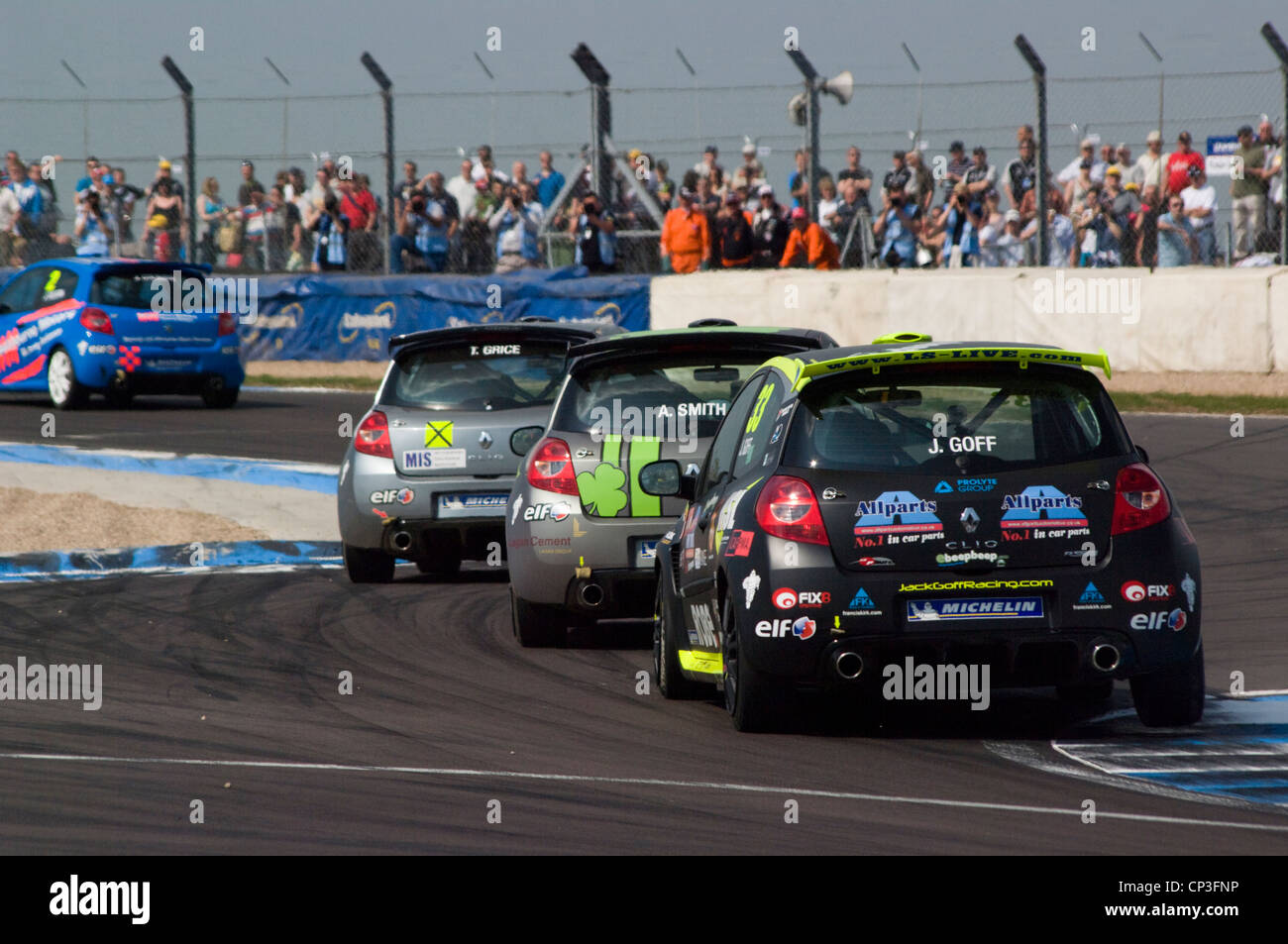 Clio racing cars push through the chicane nose to tail Stock Photo
