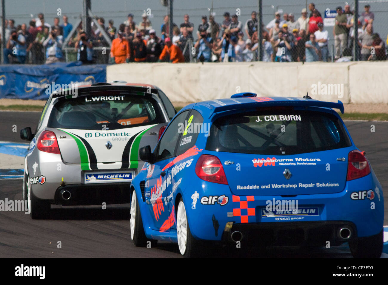 Crowds watch very close Clio racing cars Stock Photo