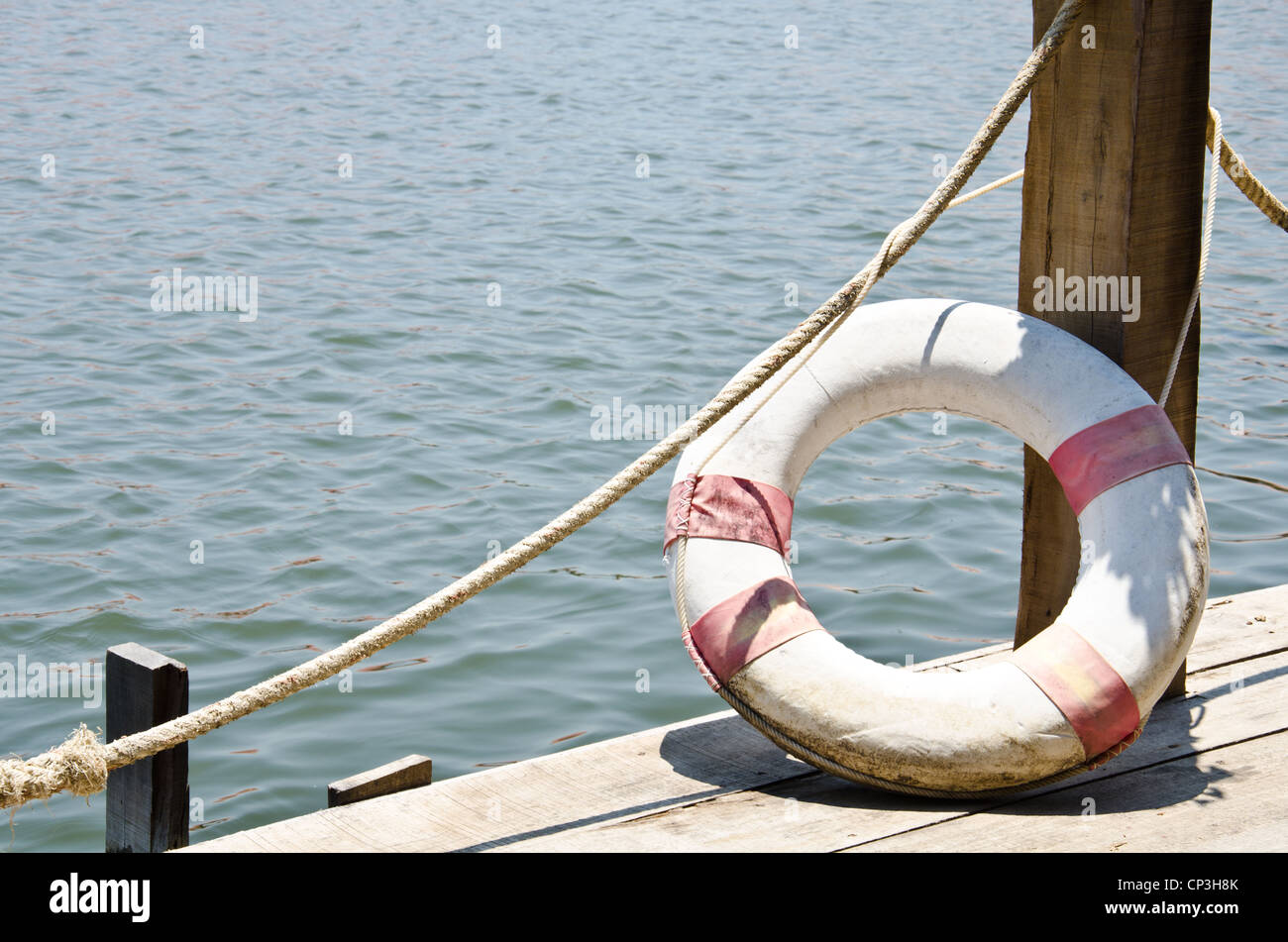 Life buoy attached dock for a lifetime of swimming. Stock Photo