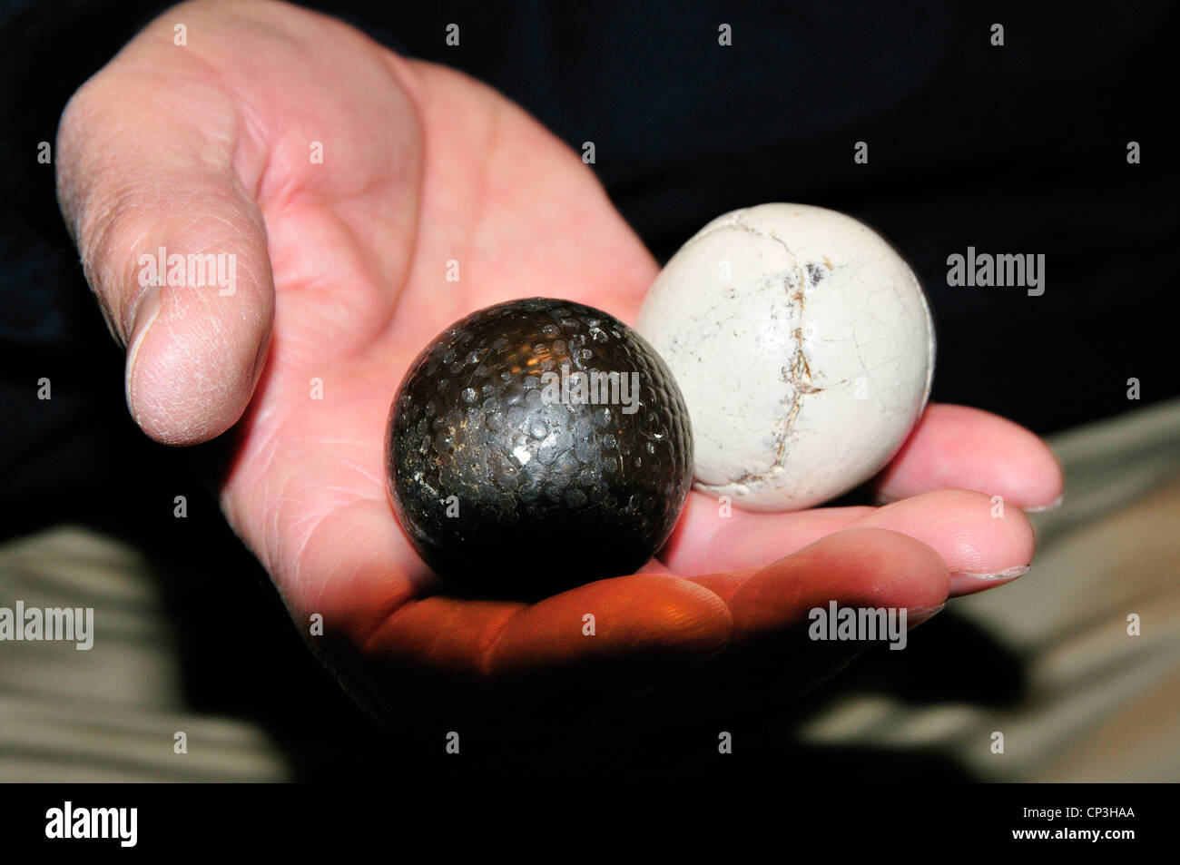 Vintage golf balls at the World Golf Hall of Fame. The ball on the right is gutta-percha; on the left stuffed leather. Stock Photo