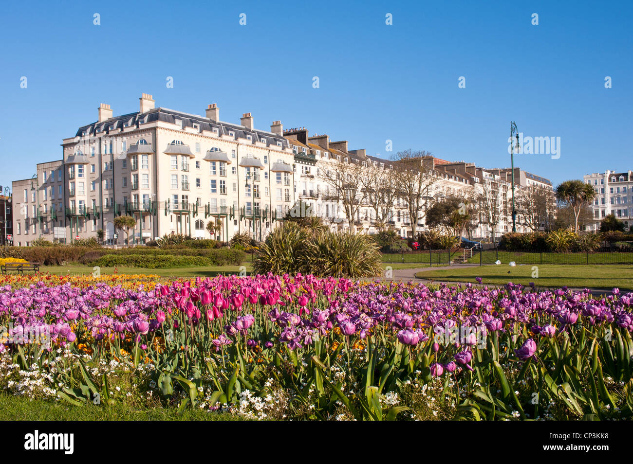 HASTINGS, EAST SUSSEX, UK - APRIL 30, 2012: Small garden on Grand Parade lined with attractive Victorian buildings Stock Photo