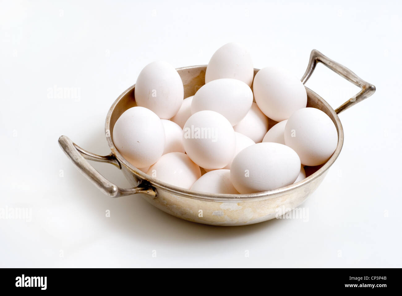 Silver bowl with white organic free-range chicken eggs. Stock Photo