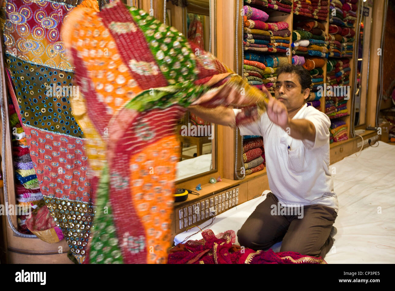 A man selling material in the Johari Bazaar, Jaipur, India Stock Photo