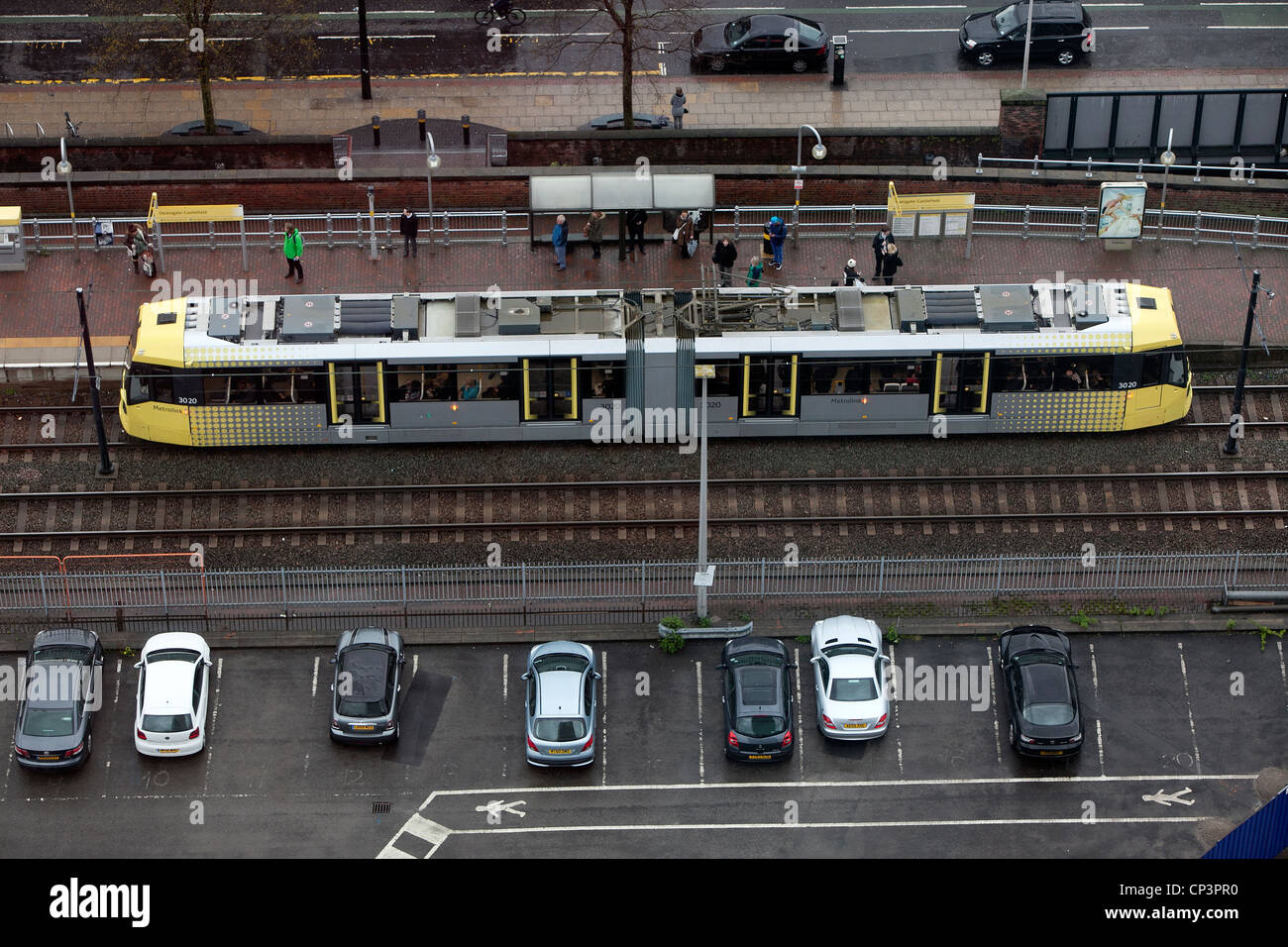 aerial-view-of-a-metrolink-tram-at-a-tram-stop-in-manchester-city