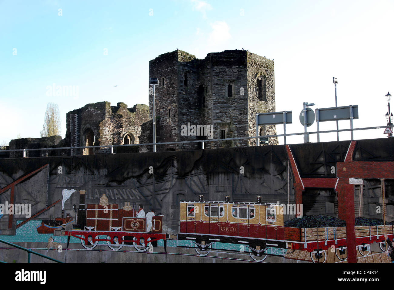 Newport Town Centre, Newport Castle with mural depicting Newports'  industrial past in the foreground . Stock Photo