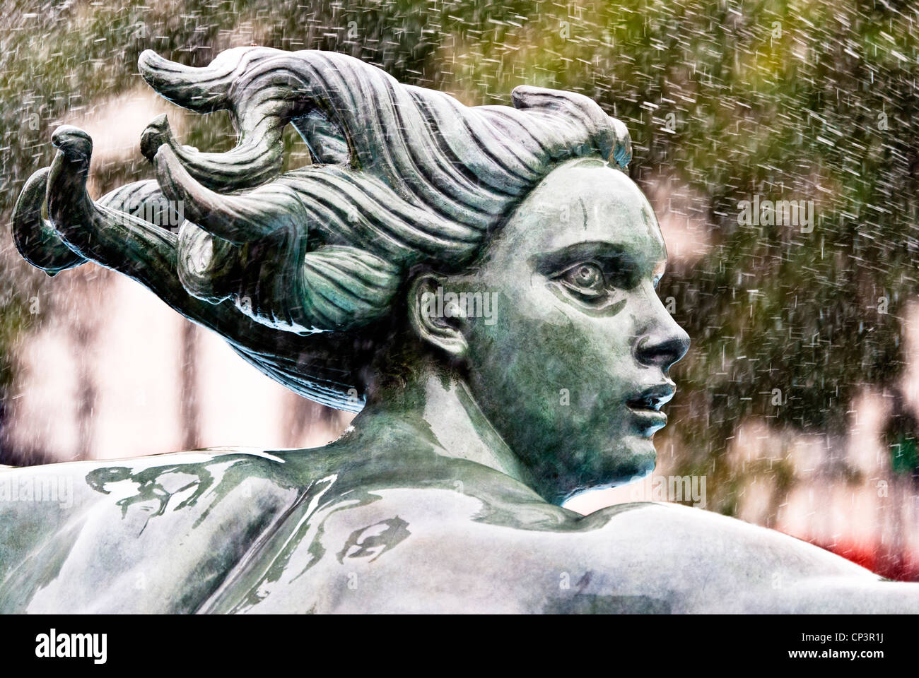 A figure of one of the fountain sculptures in Trafalgar Square, London, England, UK Stock Photo