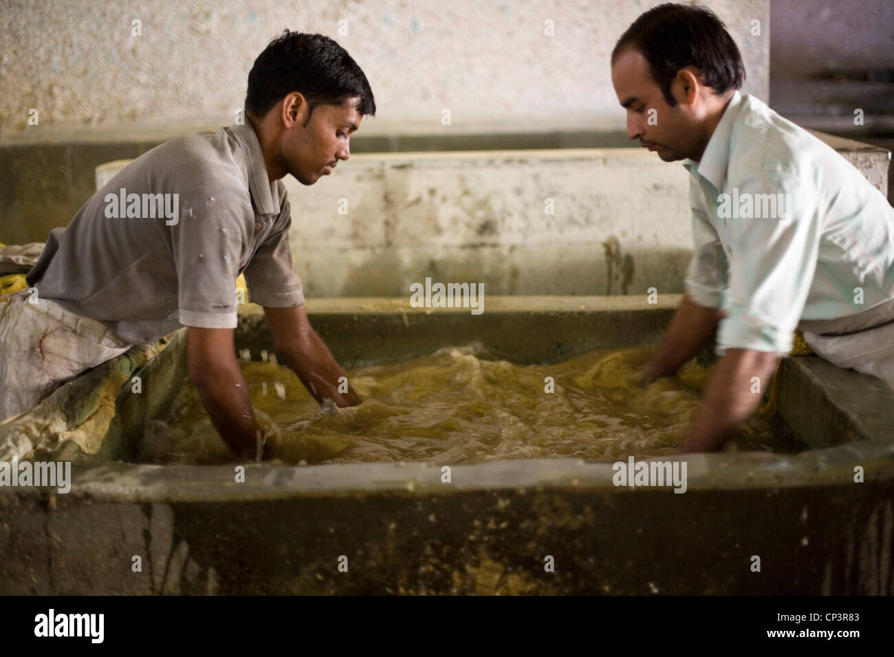 Workers making paper by hand at a factory in Sanganer, Jaipur, India