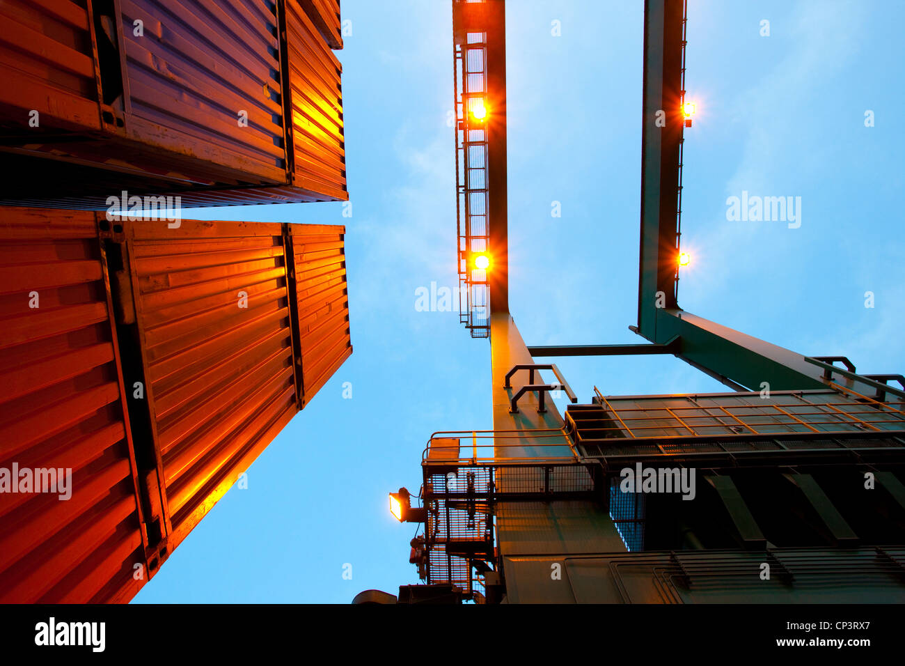 Bottom view of cranes and stack of cargo containers Stock Photo