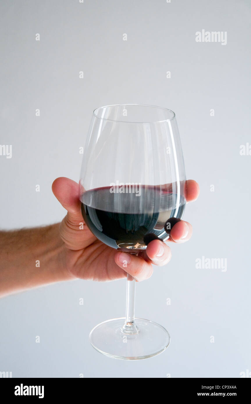 Man's hand holding a glass of red wine Stock Photo Alamy
