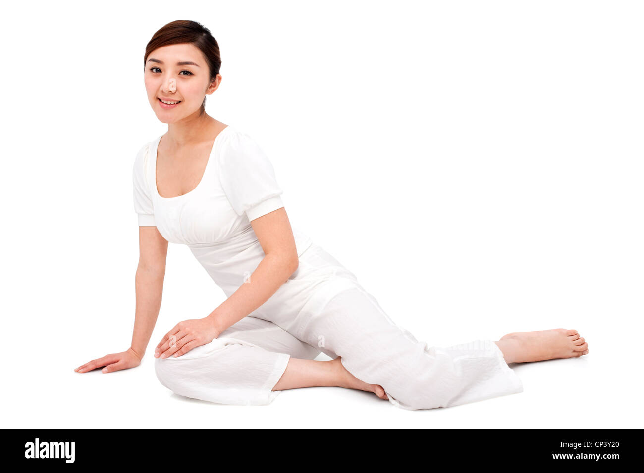 Young woman sitting on the floor and smiling Stock Photo - Alamy