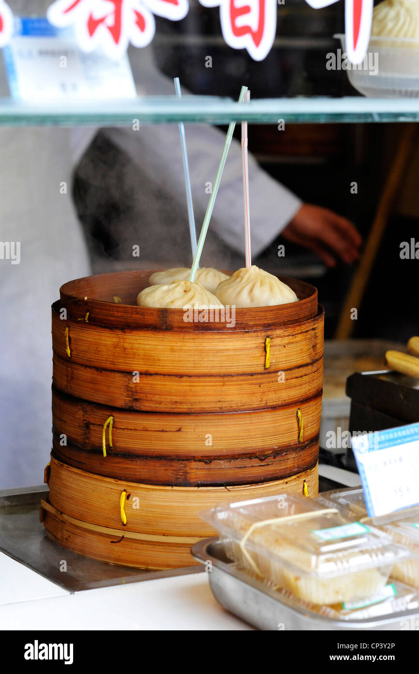 Steamed dumplings cooking in tradtional bamboo steamers in Shanghai