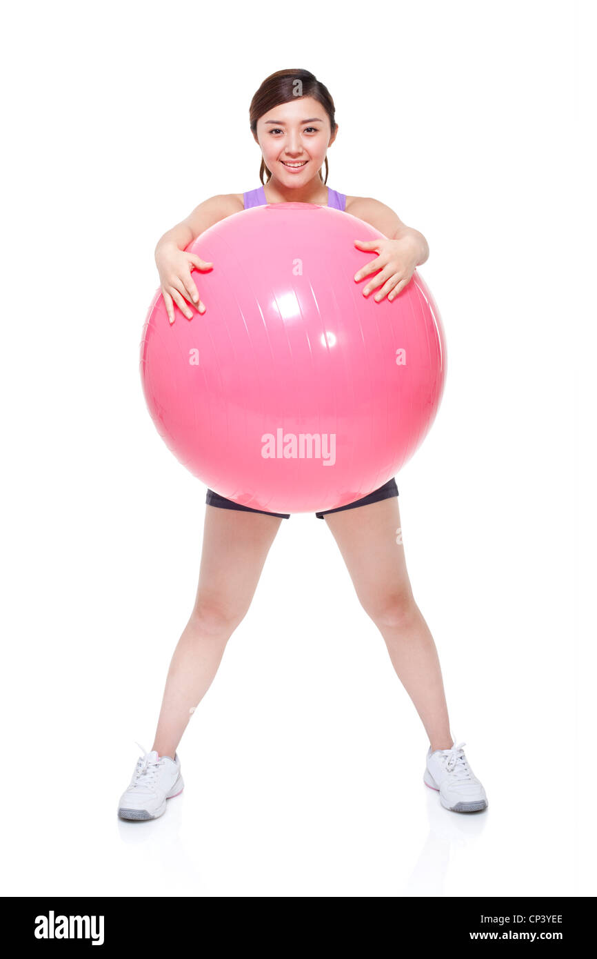 Young woman holding fitness ball Stock Photo - Alamy