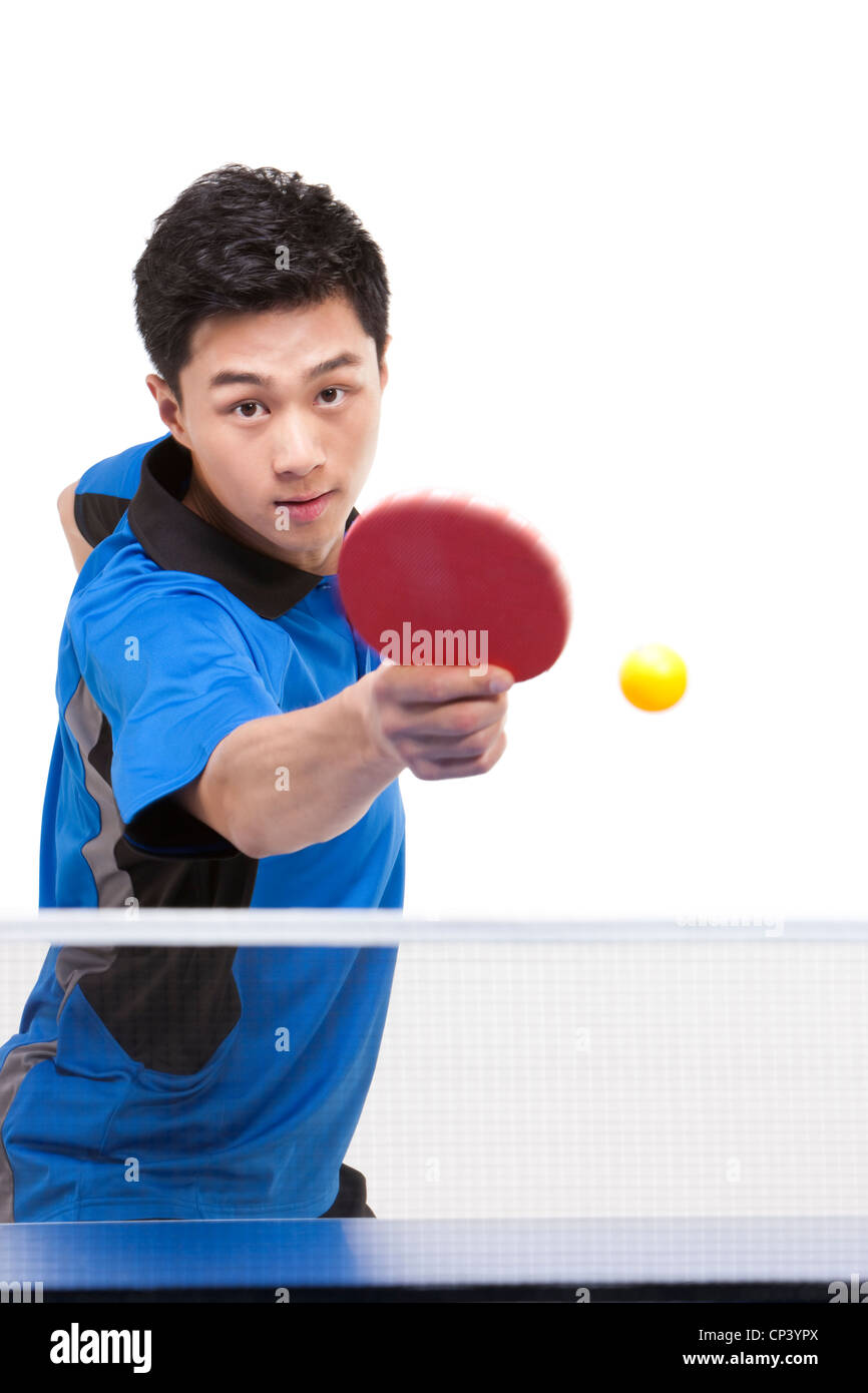 Table tennis player hitting ball Stock Photo