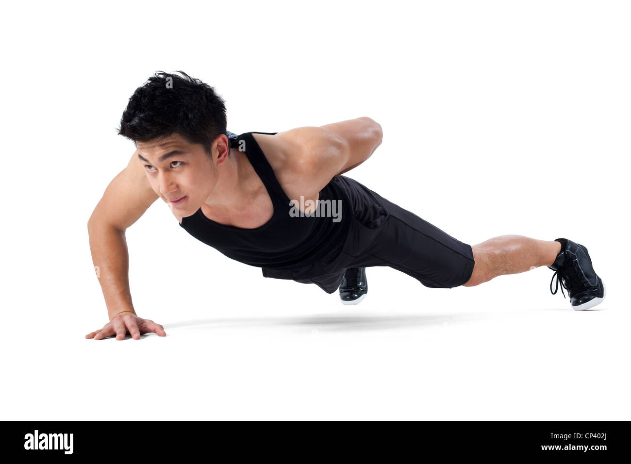 Man doing one-handed push-ups Stock Photo