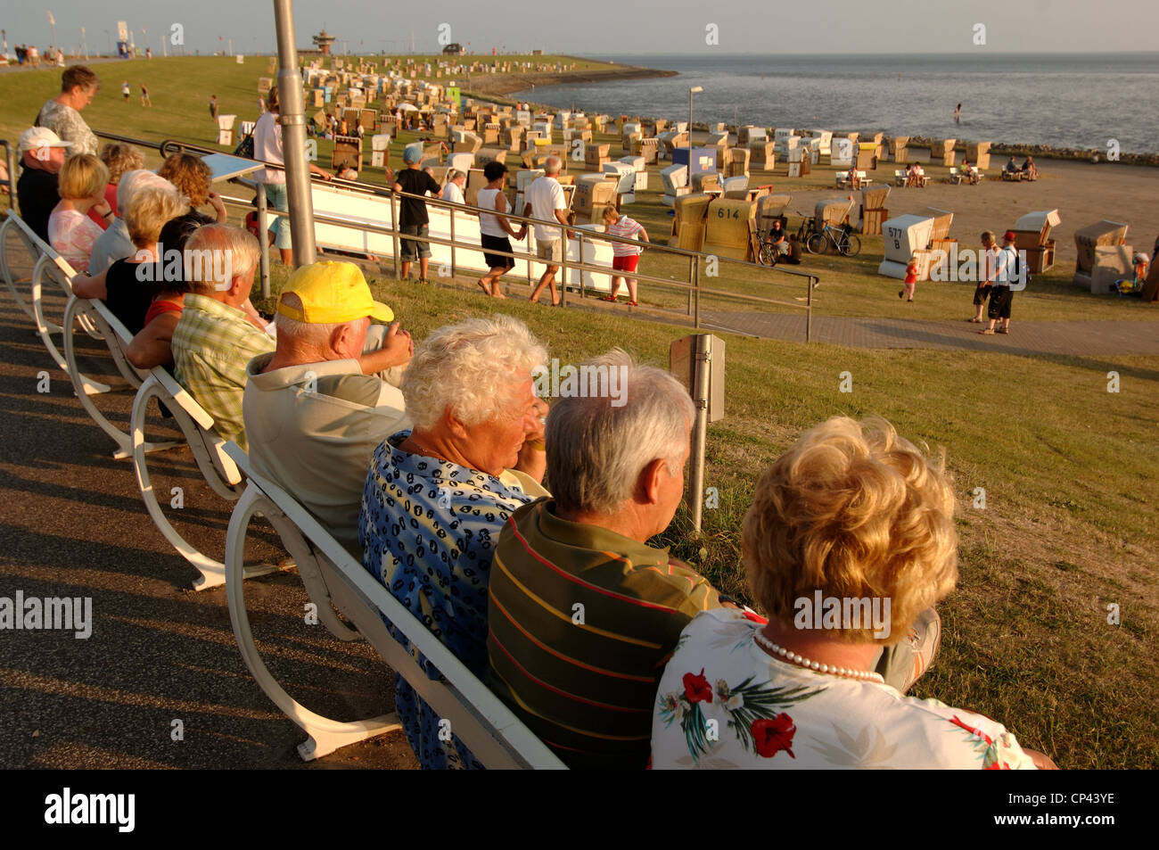 Germany - Schleswig-Holstein - Busum. People Sitting On Benches Along ...