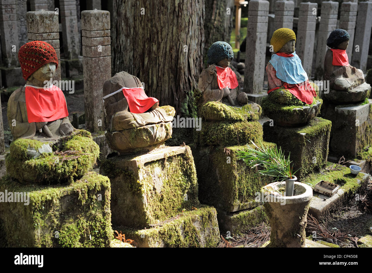 decorated Jizo statues one without head at Okunoin cemetery, Koya