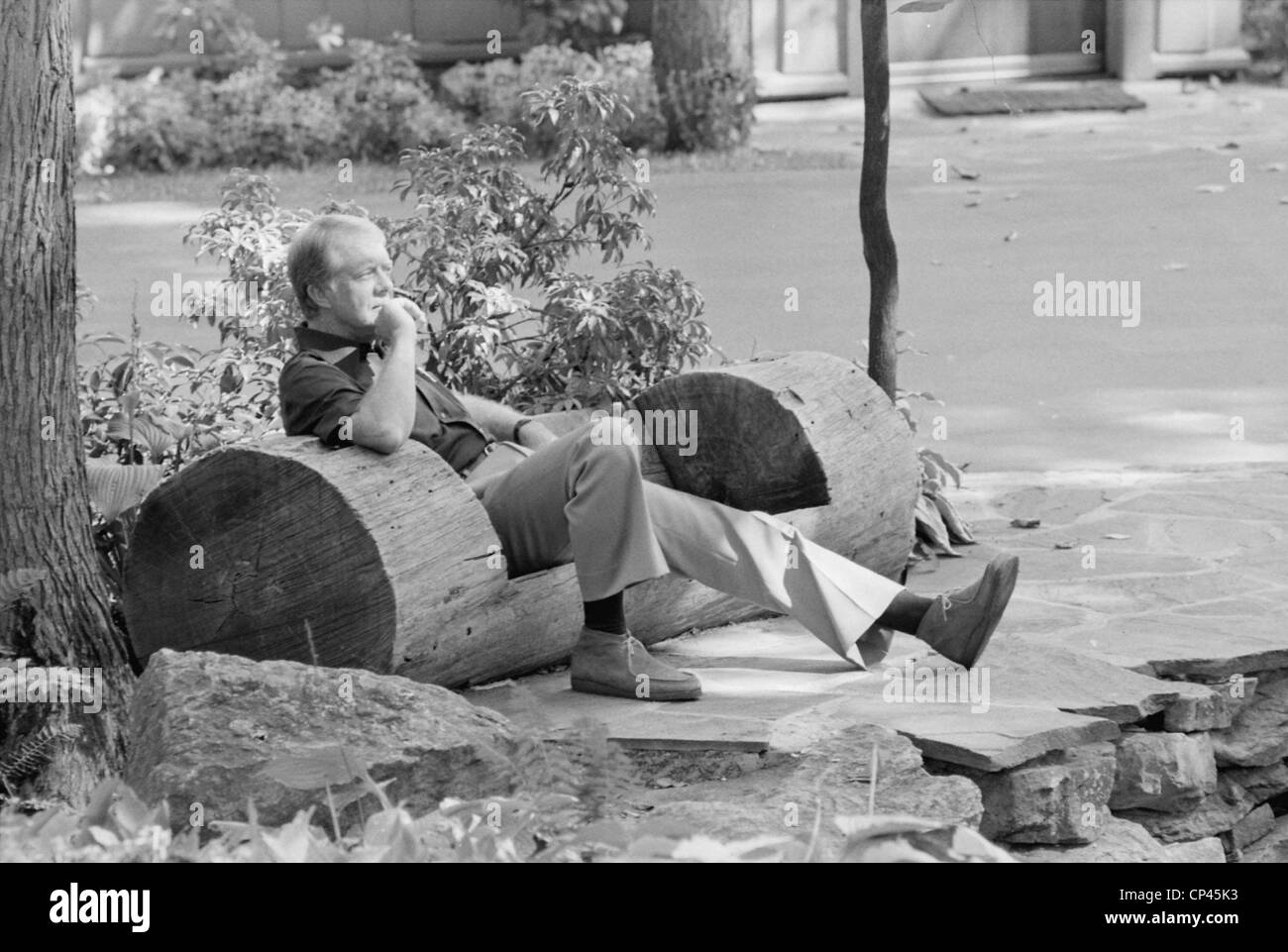 President Jimmy Carter sitting in a rustic log hewn chair at the Camp David Presidential retreat
