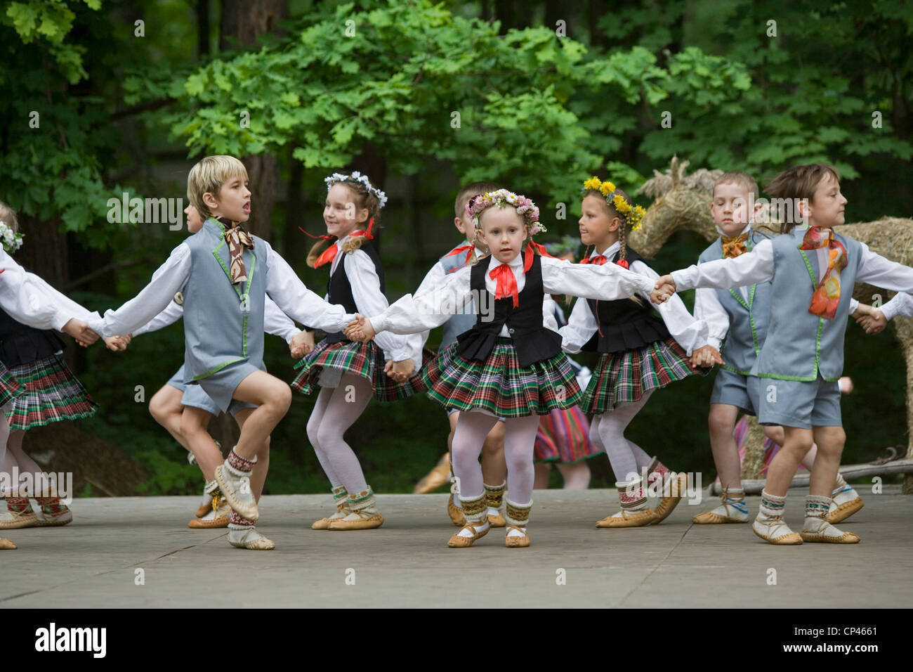 Latvia - Folk festival. Children in traditional costume as they perform a folk dance Stock Photo