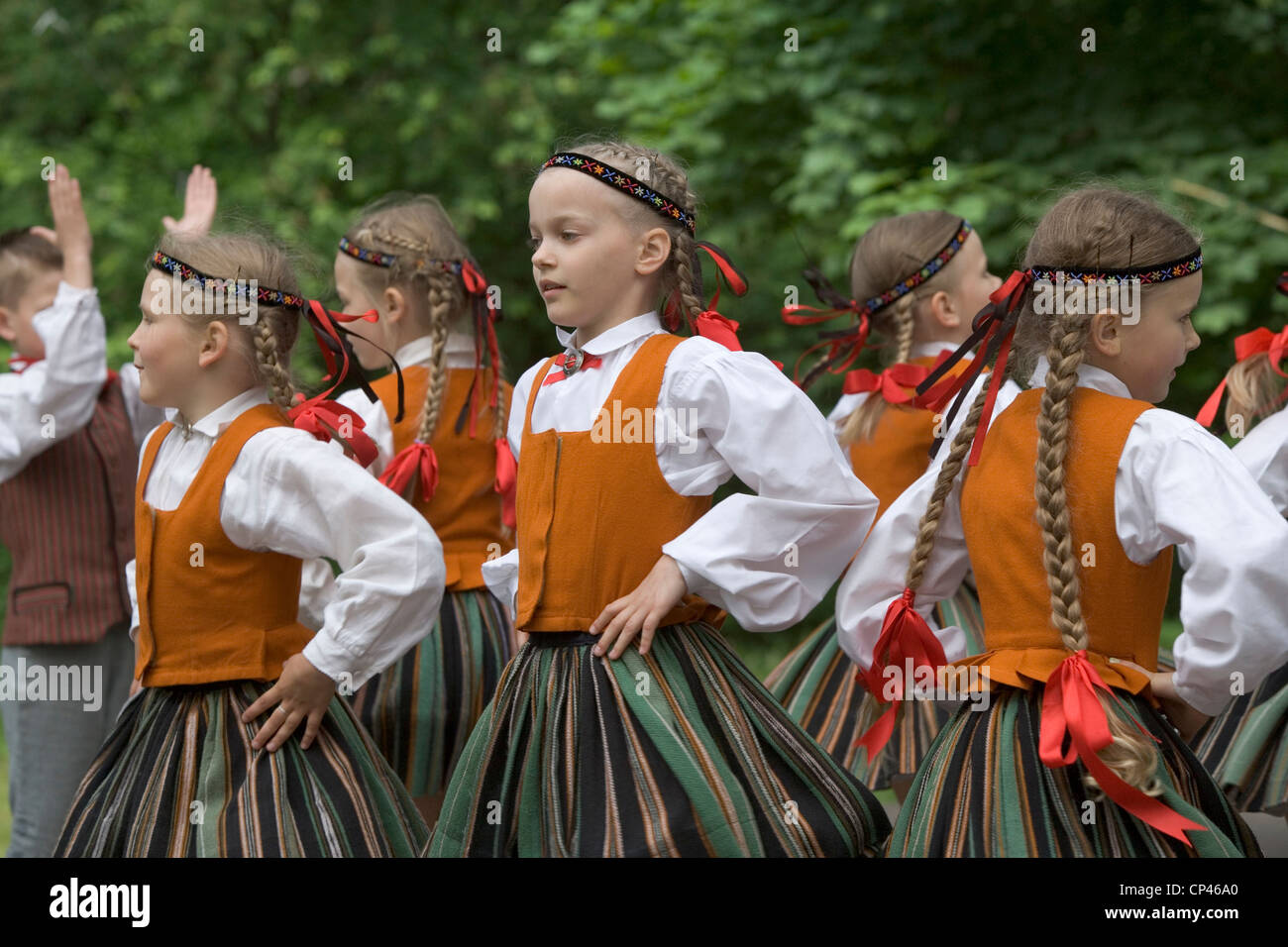 Latvia - Folk festival. Girls in traditional costume as they perform a folk dance Stock Photo
