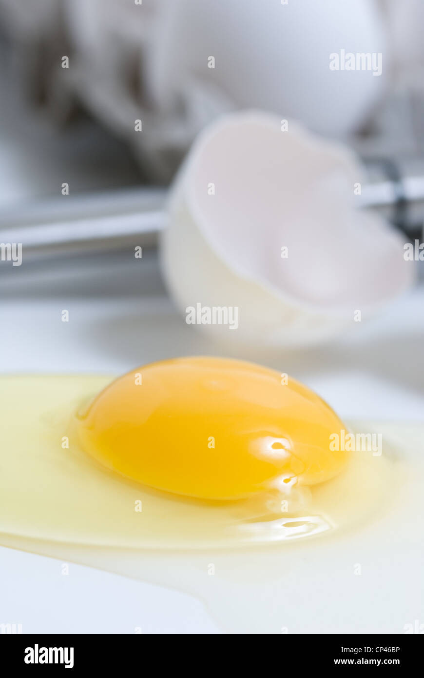 Close up of a raw cracked egg in macro photography. Stock Photo