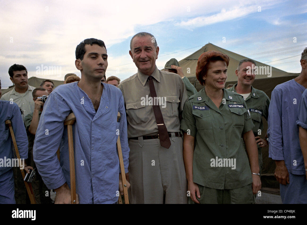 President Johnson in South Vietnam. LBJ with an unsmiling wounded US soldier and Air Force Nurse at Cam Ranh Bay, South Stock Photo