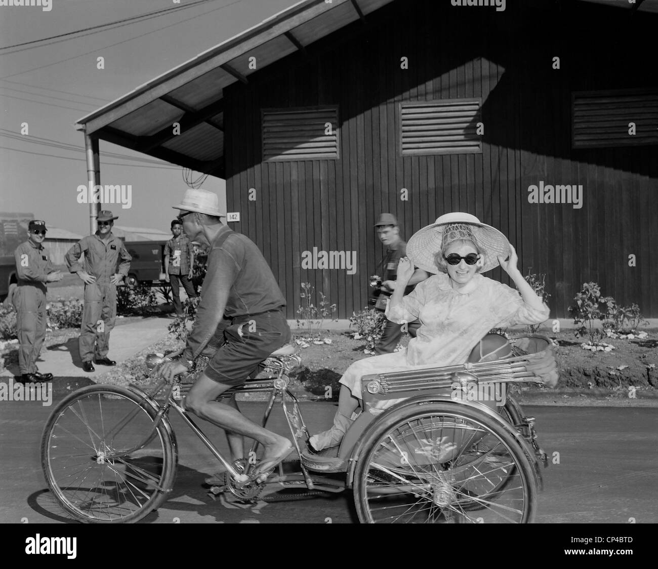 USO entertains troops in Thailand. Comedienne Phyllis Diller rides in a tricycle rickshaw as the Bob Hope USO Christmas show Stock Photo