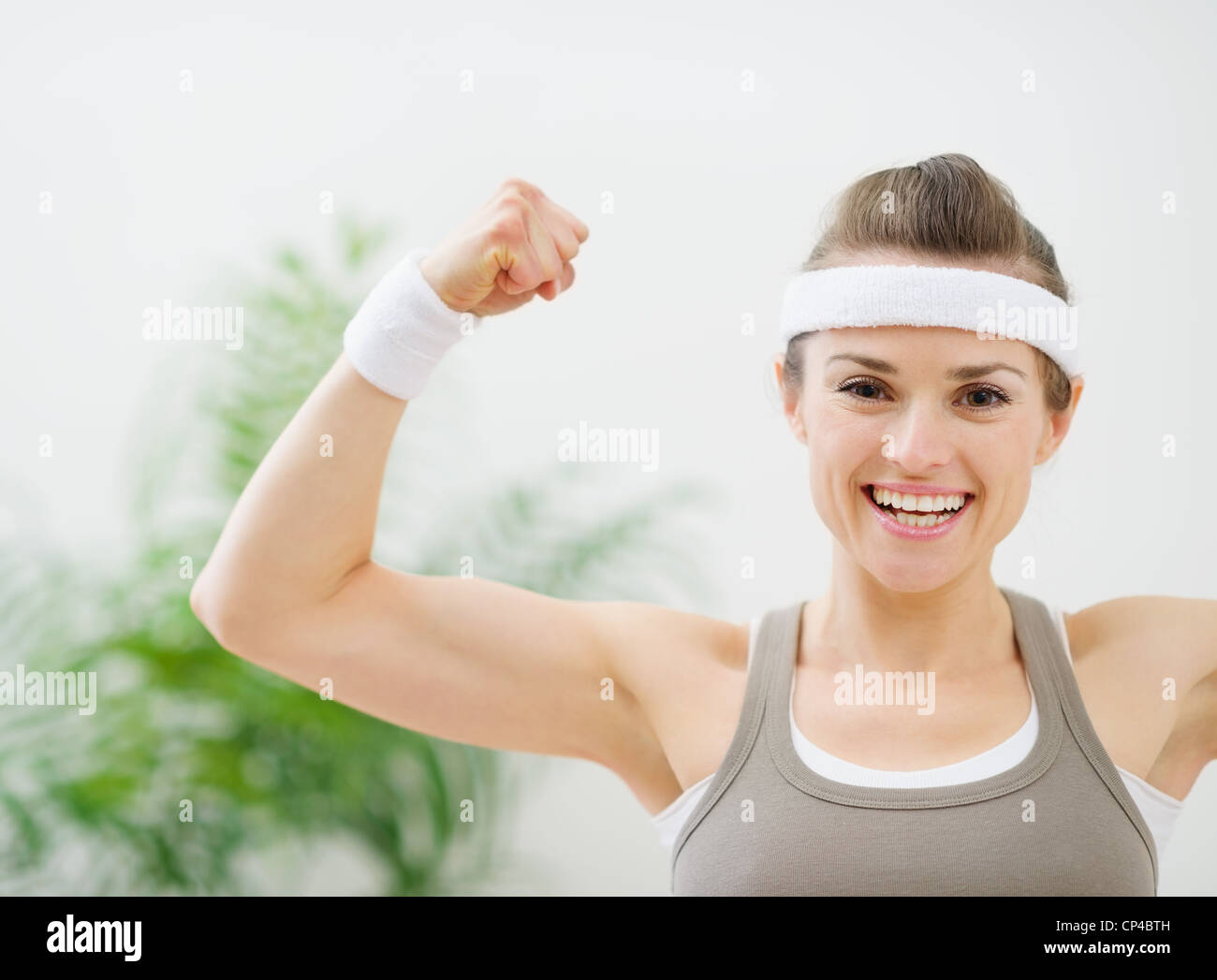 Happy sporty girl showing biceps Stock Photo Alamy