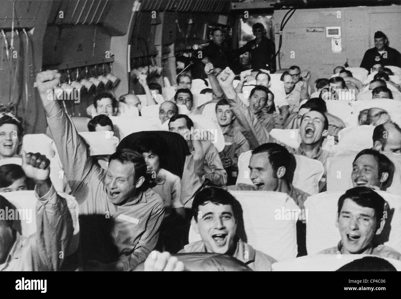 Cheering American POWs. American servicemen cheer as their aircraft takes off from an airfield near Hanoi after their release Stock Photo