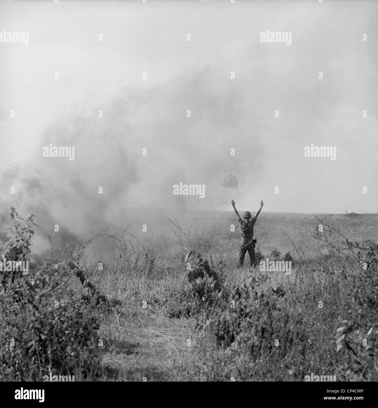 Vietnam War. US Army soldier directs a helicopter to pick up soldiers  injured after a parachute drop in South Vietnam. Oct Stock Photo - Alamy