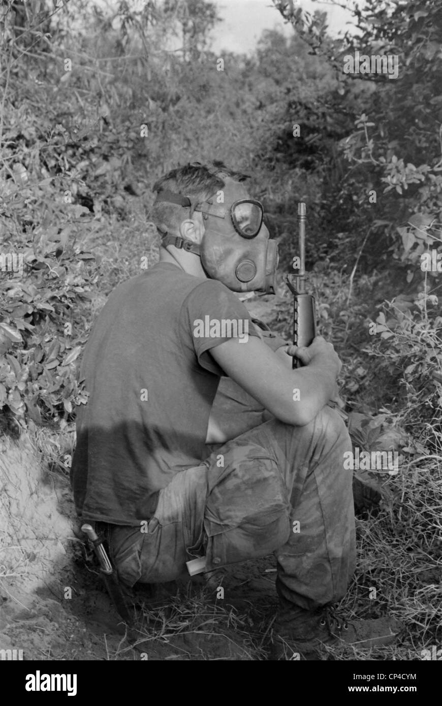 Vietnam War. US Marine wearing gas mask while waiting to enter a Viet Cong tunnel 22 miles south of DaNang, Vietnam. 1968. Stock Photo