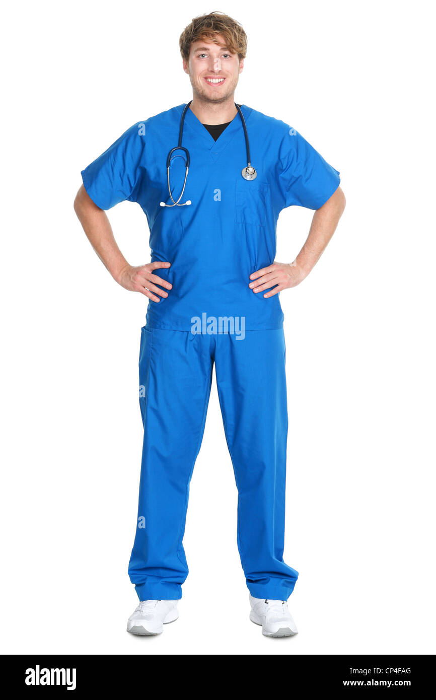 Portrait of confident young male nurse wearing blue scrubs and stethoscope standing isolated on white background Stock Photo