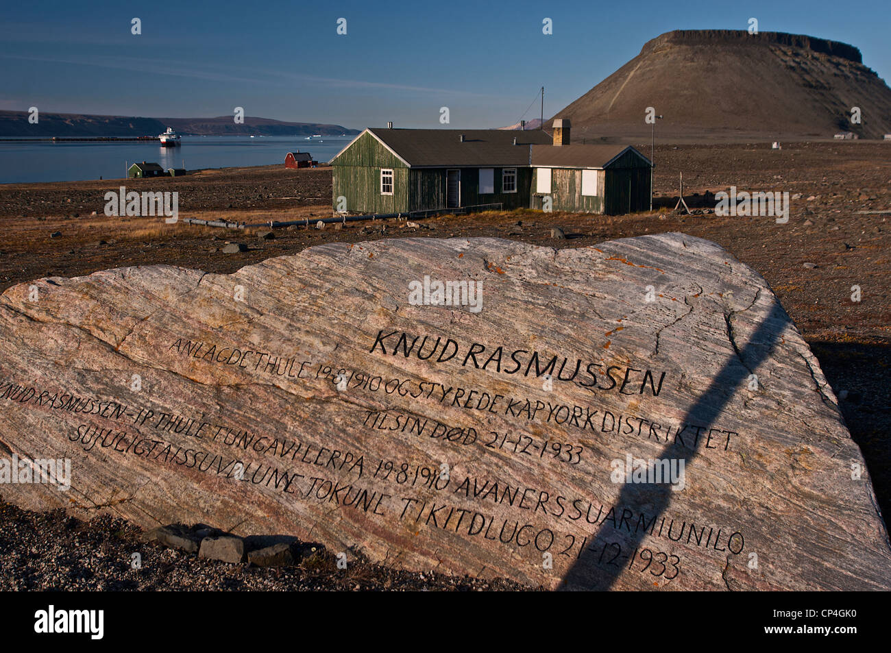 Greenland - Qaasuitsup Kommunia - Dundas. Knud Rasmussen's Memorial, on the background the polar cruise ship M/S Fram. Stock Photo